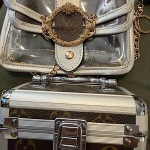 Two Silver and Brown small bags, one box shape and other clear shoulder bag